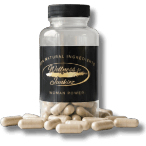Wellness Junkiez Woman Power natural dietary supplement bottle with loose capsules scattered around the base on a white background.