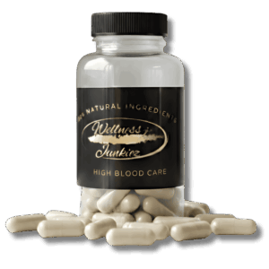 Wellness Junkiez High Blood Care natural dietary supplement bottle with black ribbed cap and herbal capsules scattered at the base on a white background.