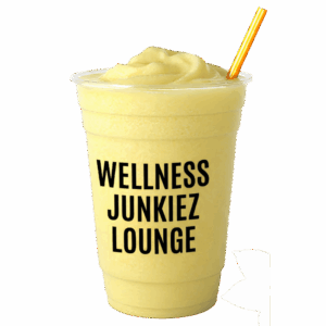 Citrus Fix Lemon Smoothie in a clear cup with Wellness Junkiez Lounge logo, yellow straw, fresh lemon slices, and green leaves on a white background.