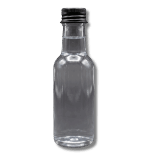 Clear miniature glass bottle filled with activated charcoal infused cleanse shot liquid on a dark background